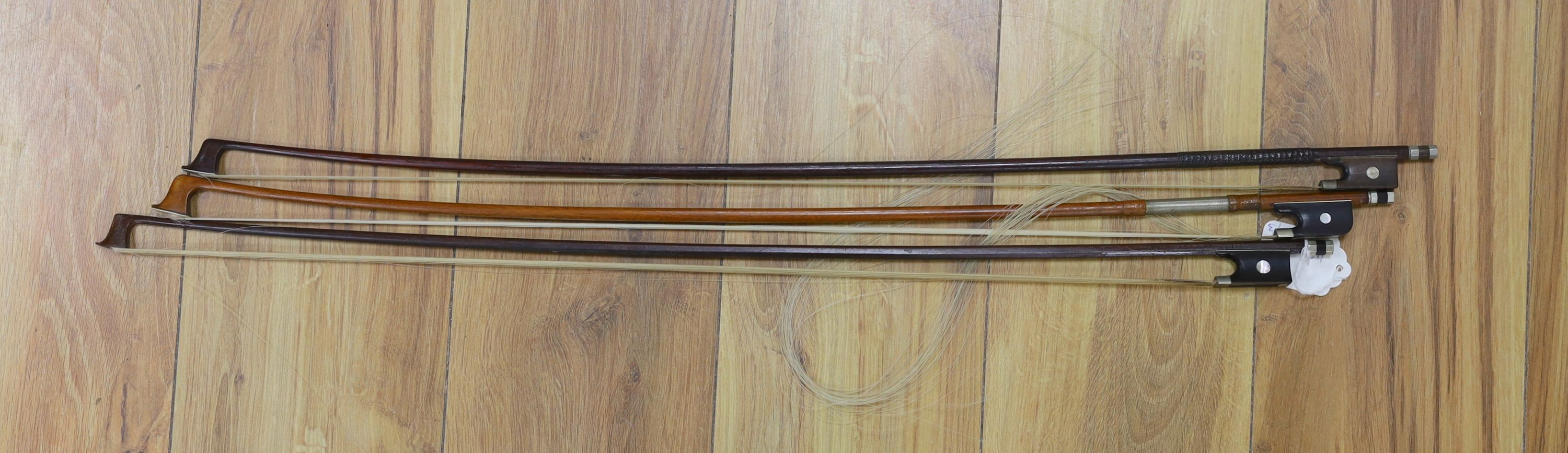 Three nickel mounted violin bows, one stamped R. R. Shields, two with ivory veneered tip - longest 75cm